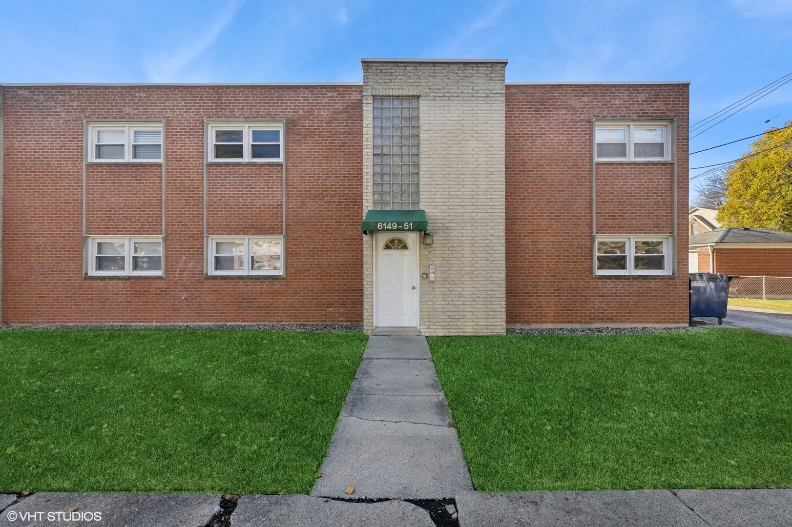 a view of a brick house with a yard