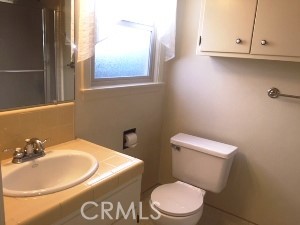 a white toilet sitting next to a bathroom sink