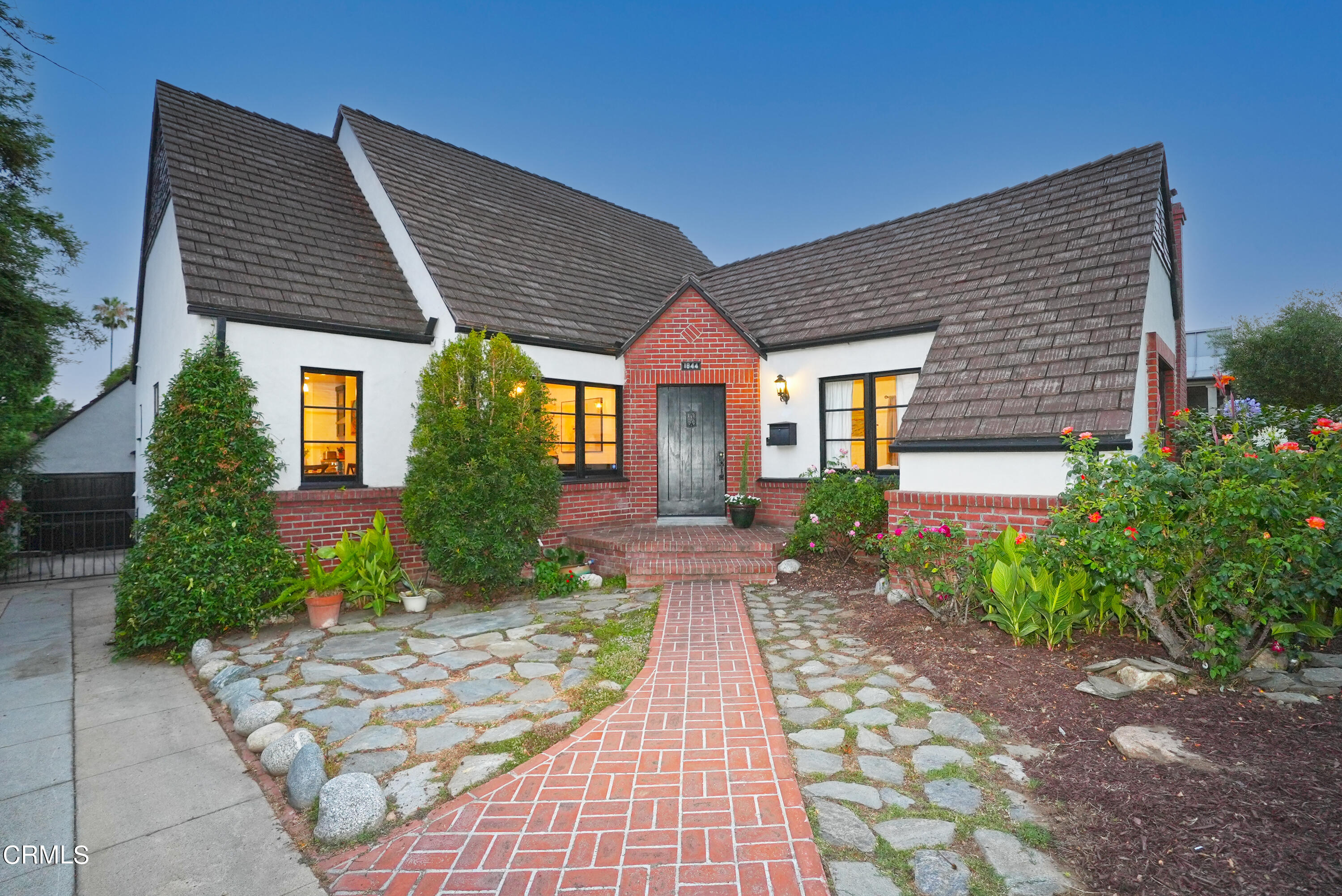 a front view of a house with garden