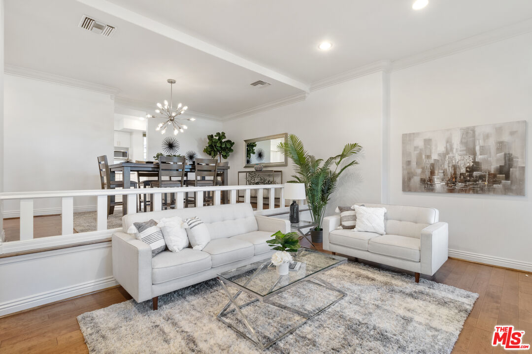 a living room with furniture and a chandelier