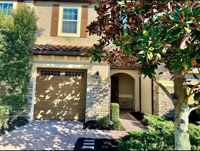 a front view of a house with plants