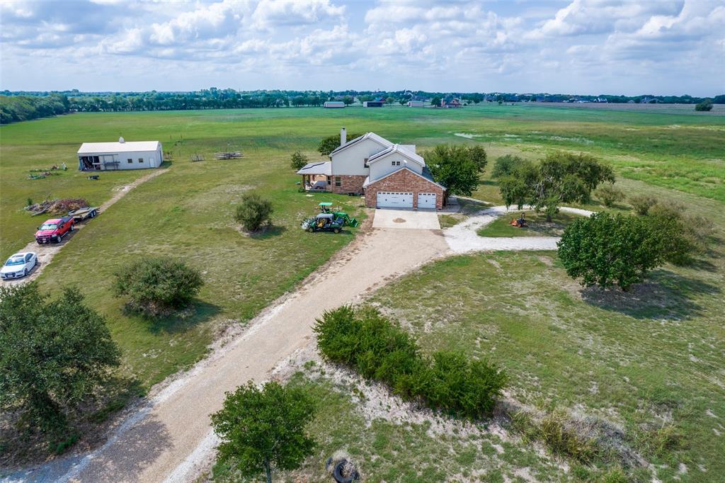 a aerial view of a house with big yard