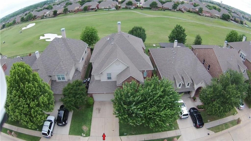 an aerial view of a house with outdoor space and street view