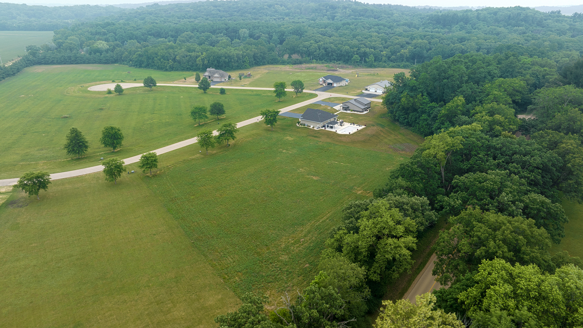 an aerial view of a houses with a lake view