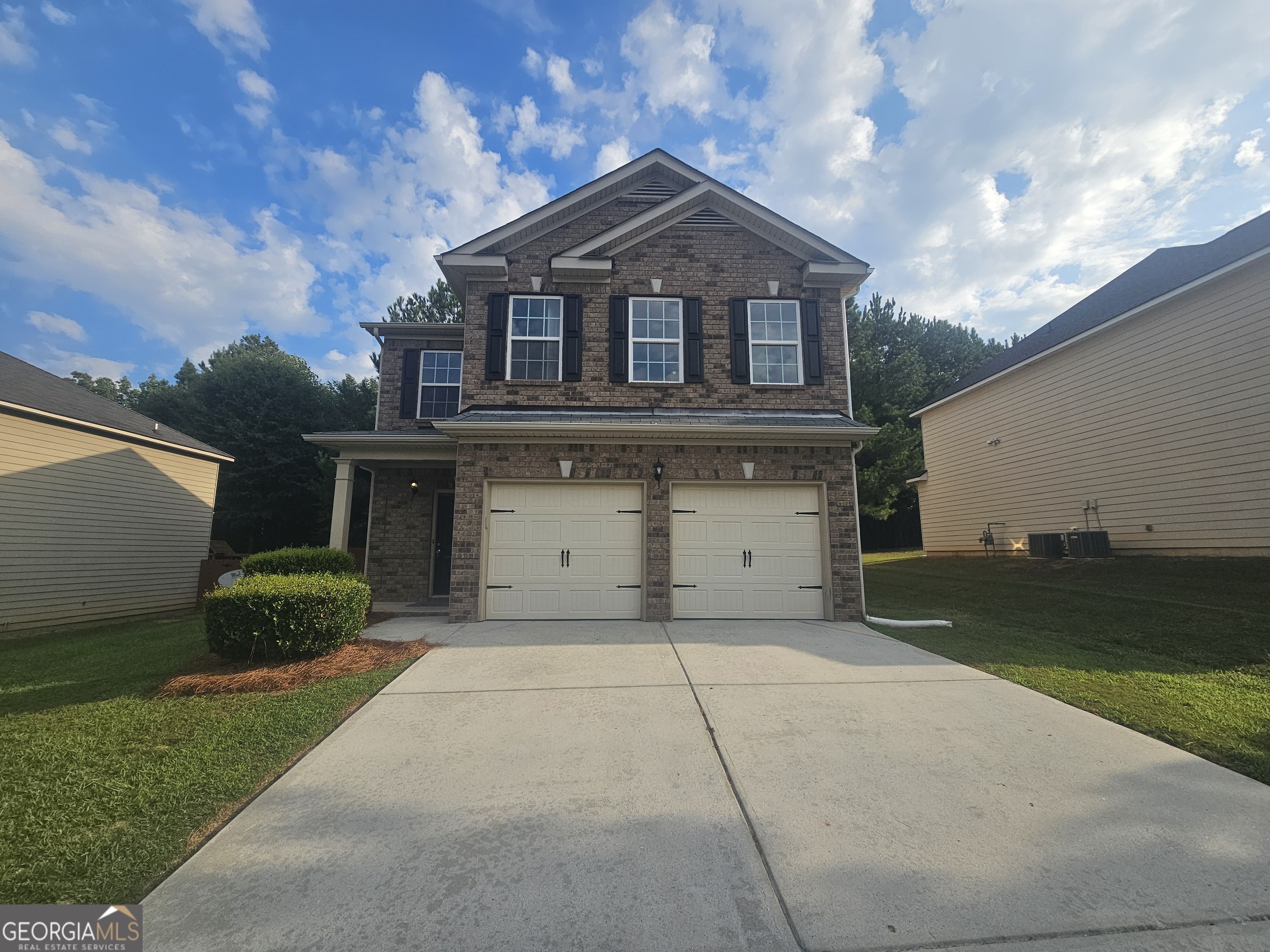 a front view of a house with a yard