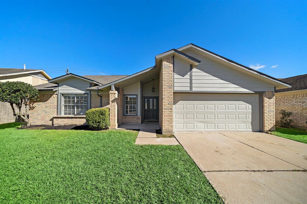 a view of a house with a yard and garage