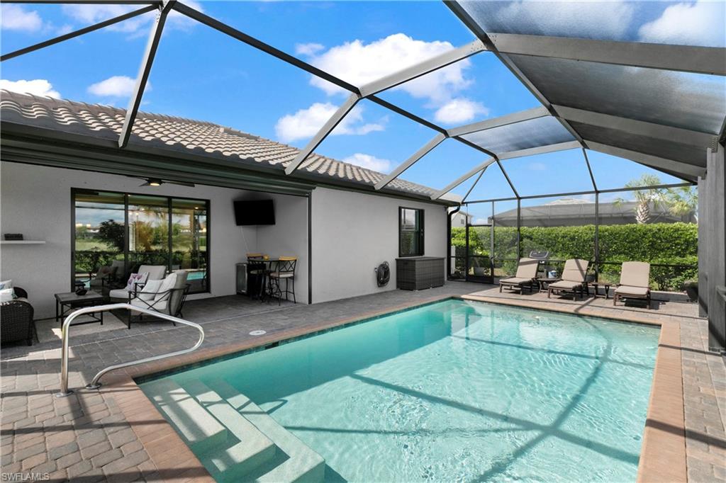 a view of a patio with table and chairs under an umbrella