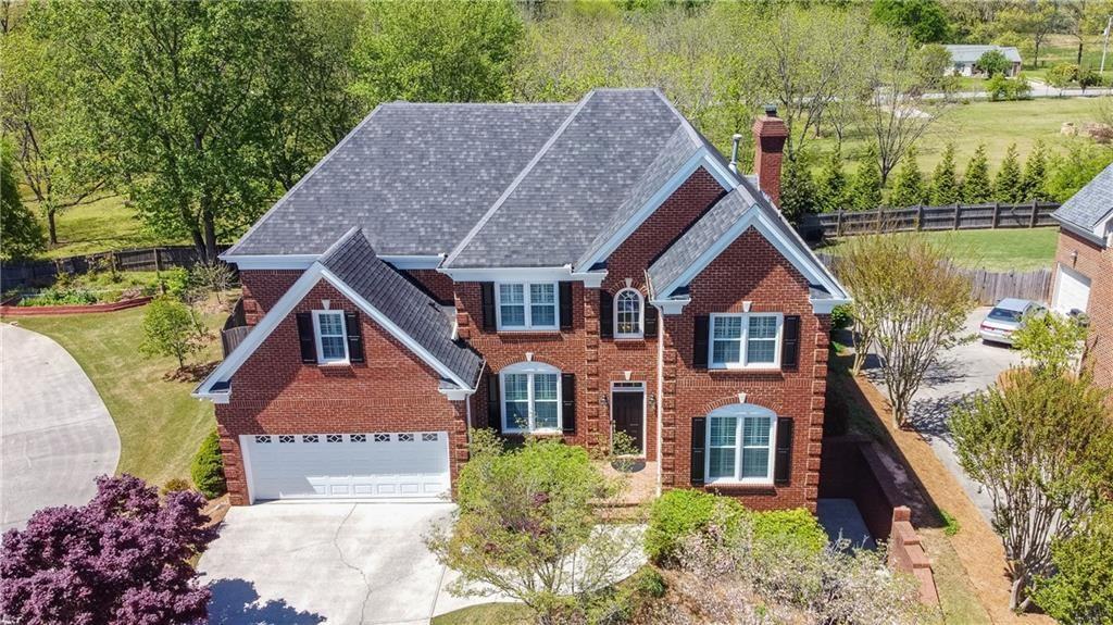 an aerial view of a house with a yard