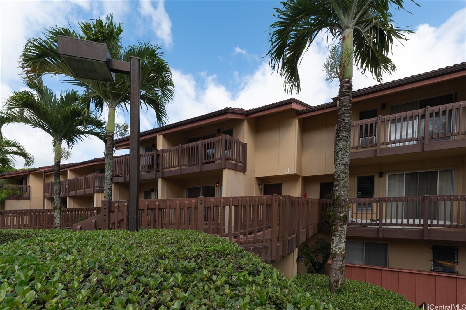 a view of multiple houses with palm trees