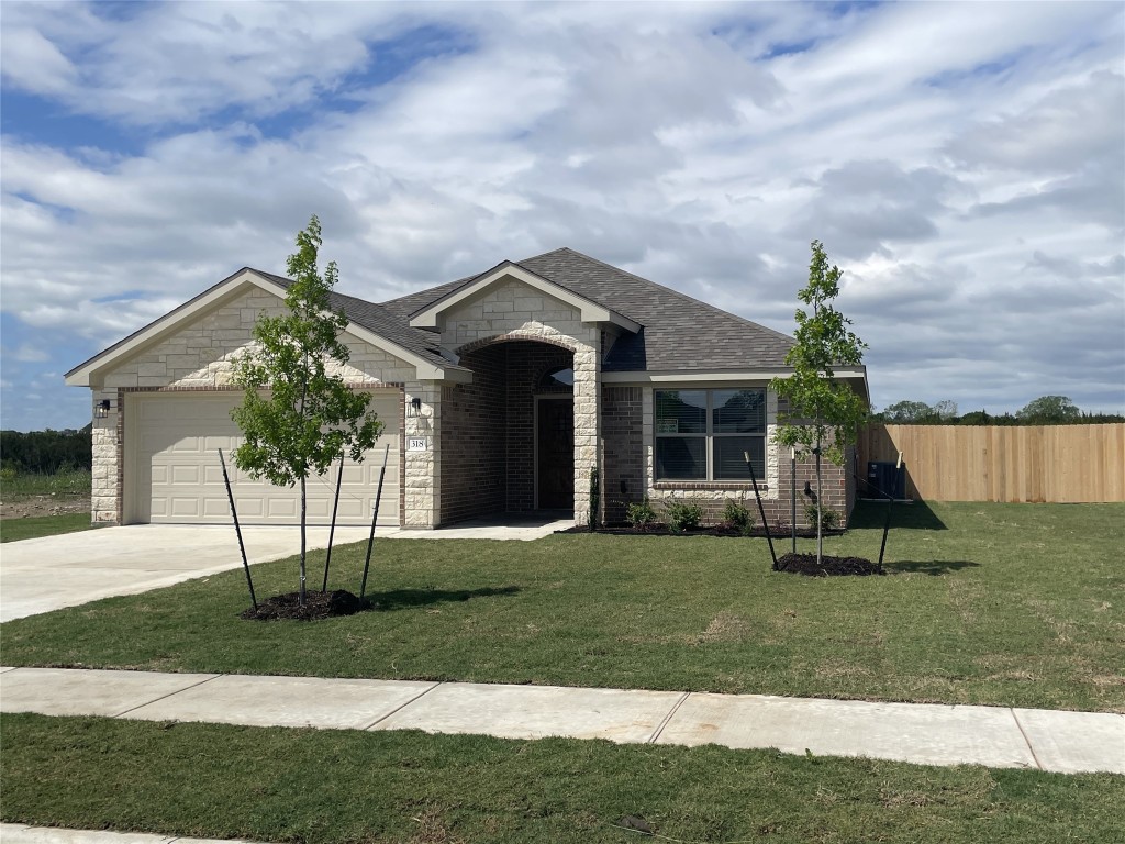 a front view of a house with a garden