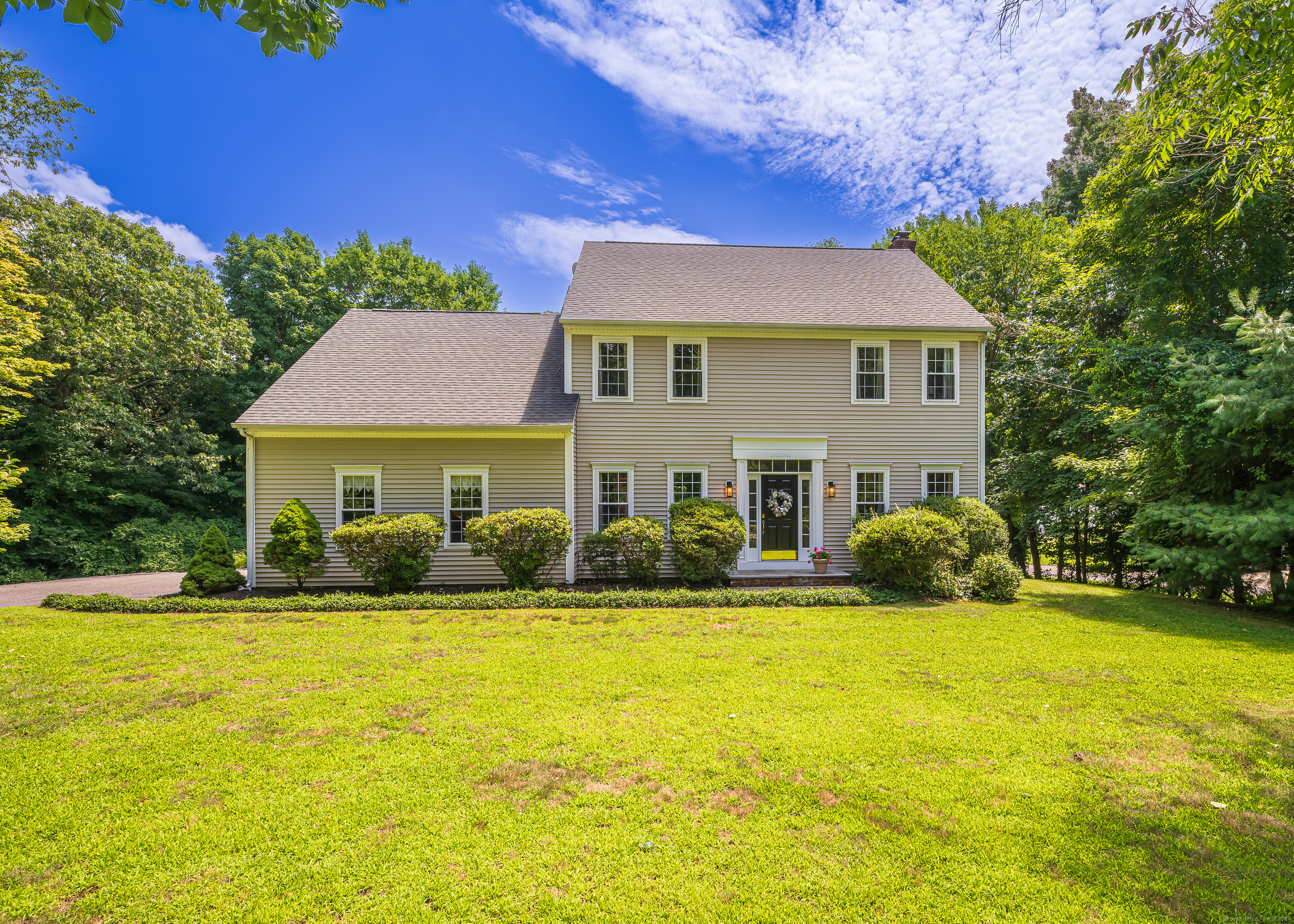 a front view of a house with a yard