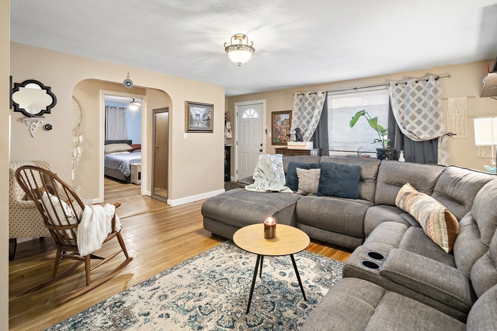 a living room with furniture ceiling fan and a rug