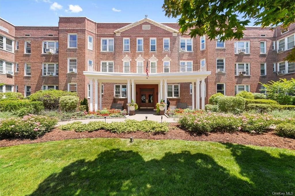 a front view of a residential apartment building with a yard