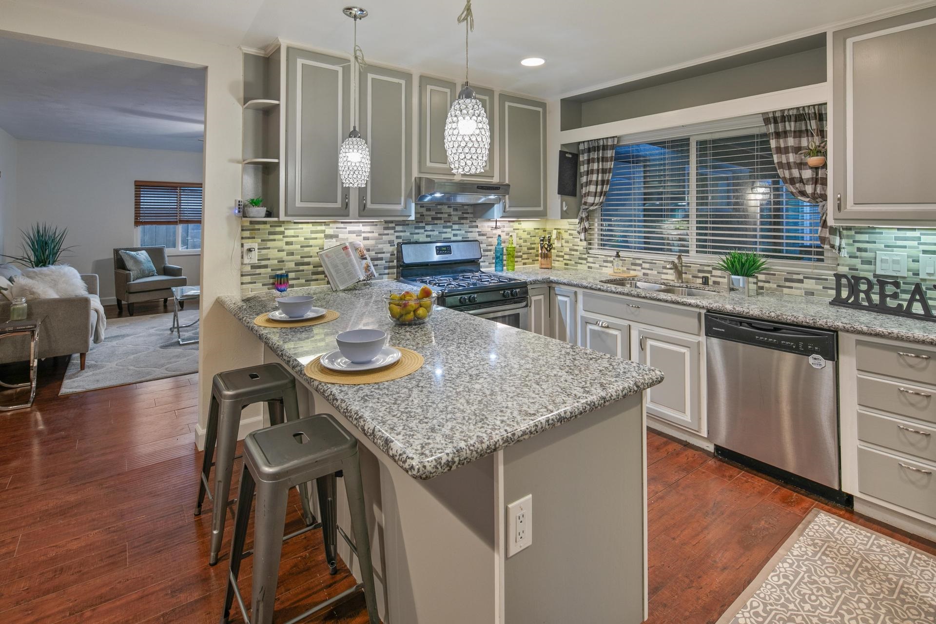 a kitchen with center island table and chairs