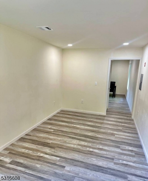 a view of a room with wooden floor