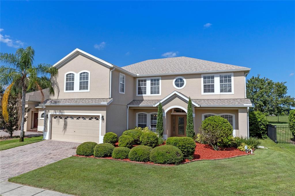 a front view of a house with a yard and garage