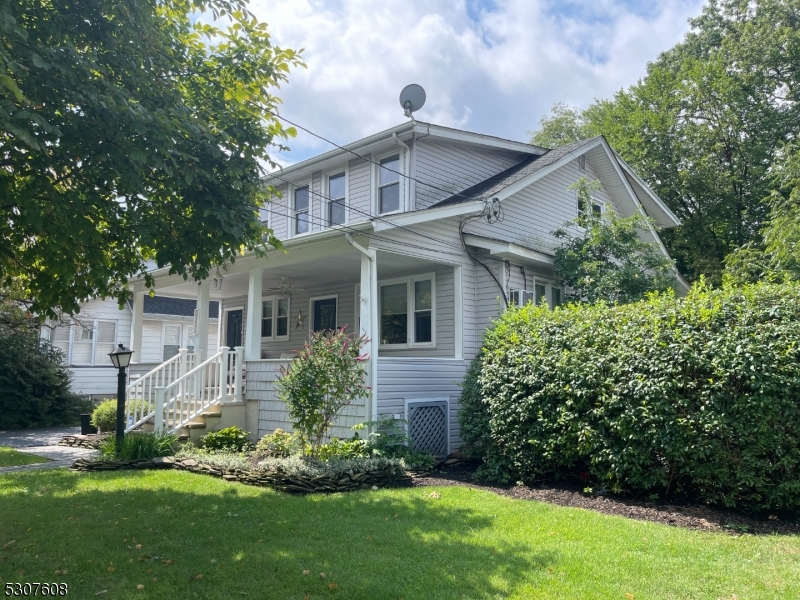 a front view of house with a garden