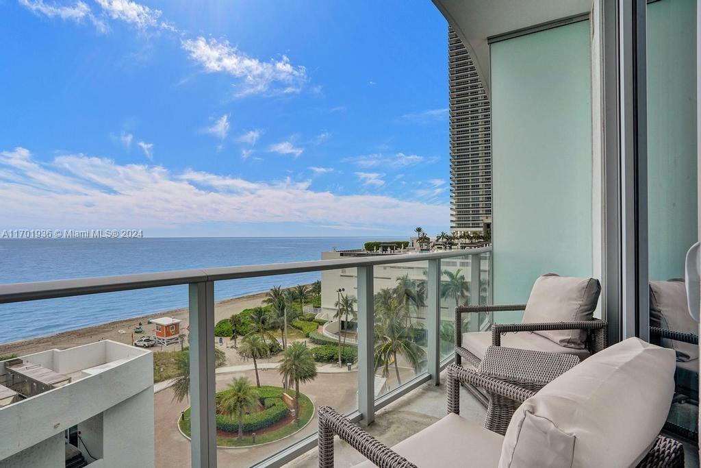 a view of a balcony with furniture