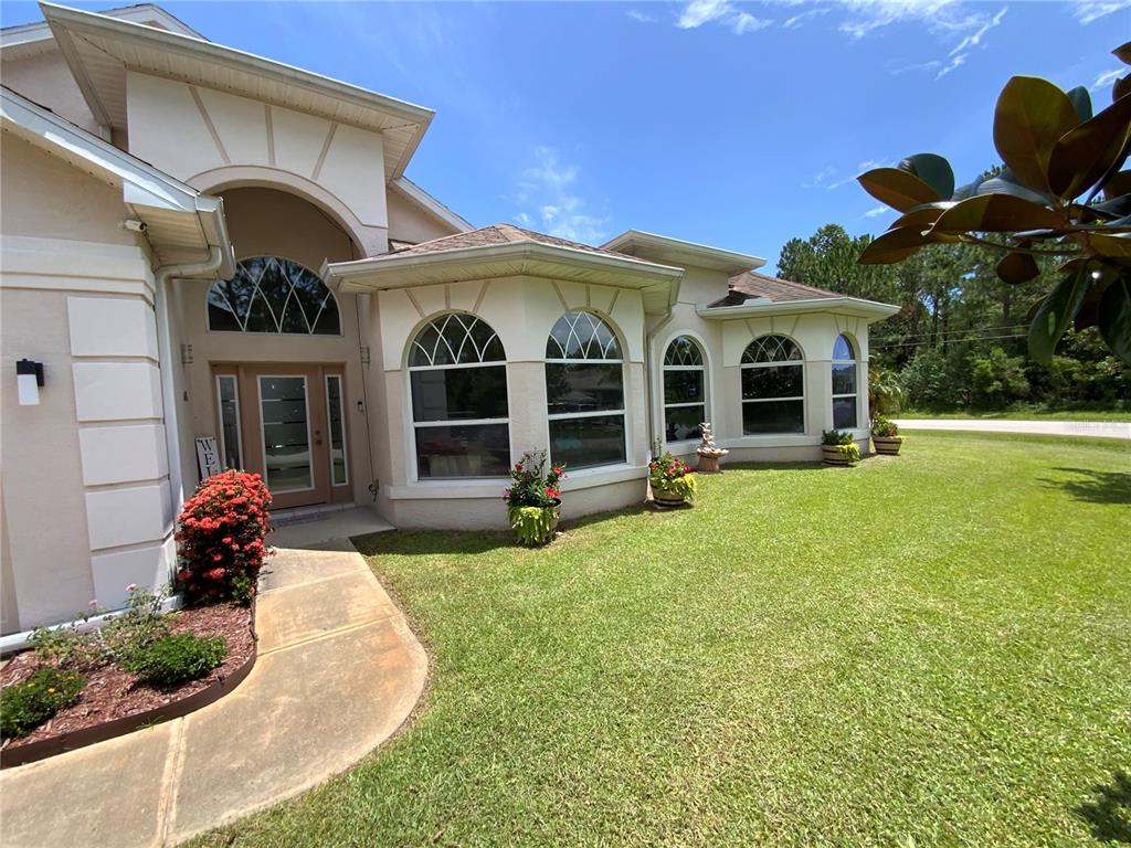 a front view of a house with garden