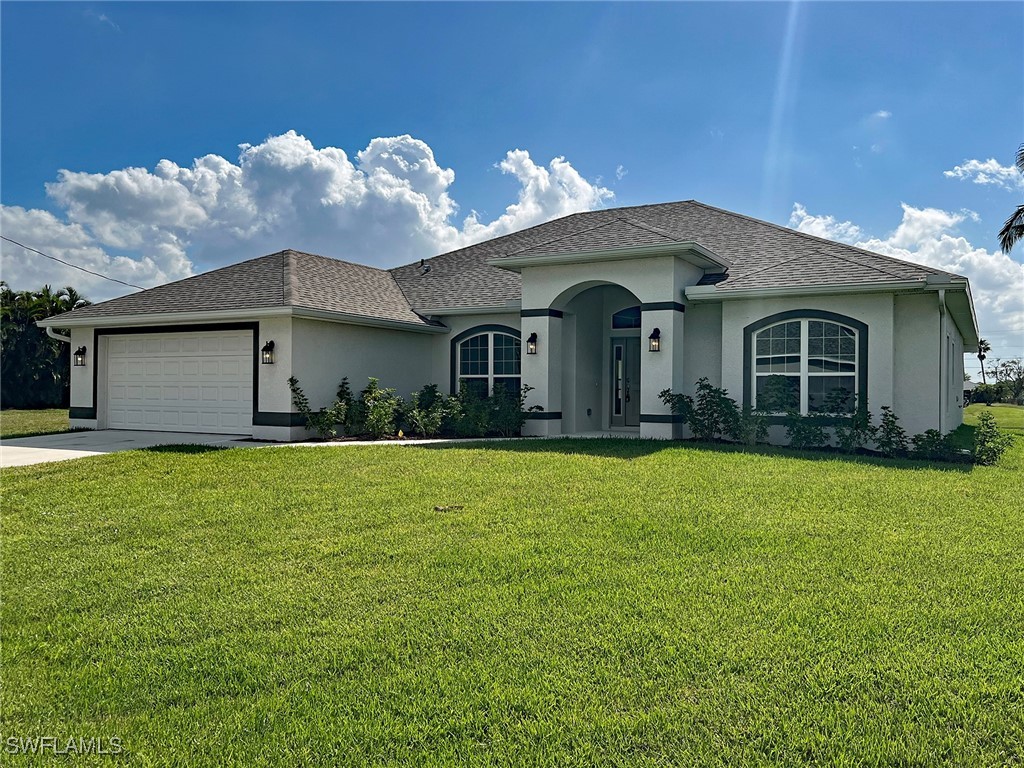 a front view of a house with a garden