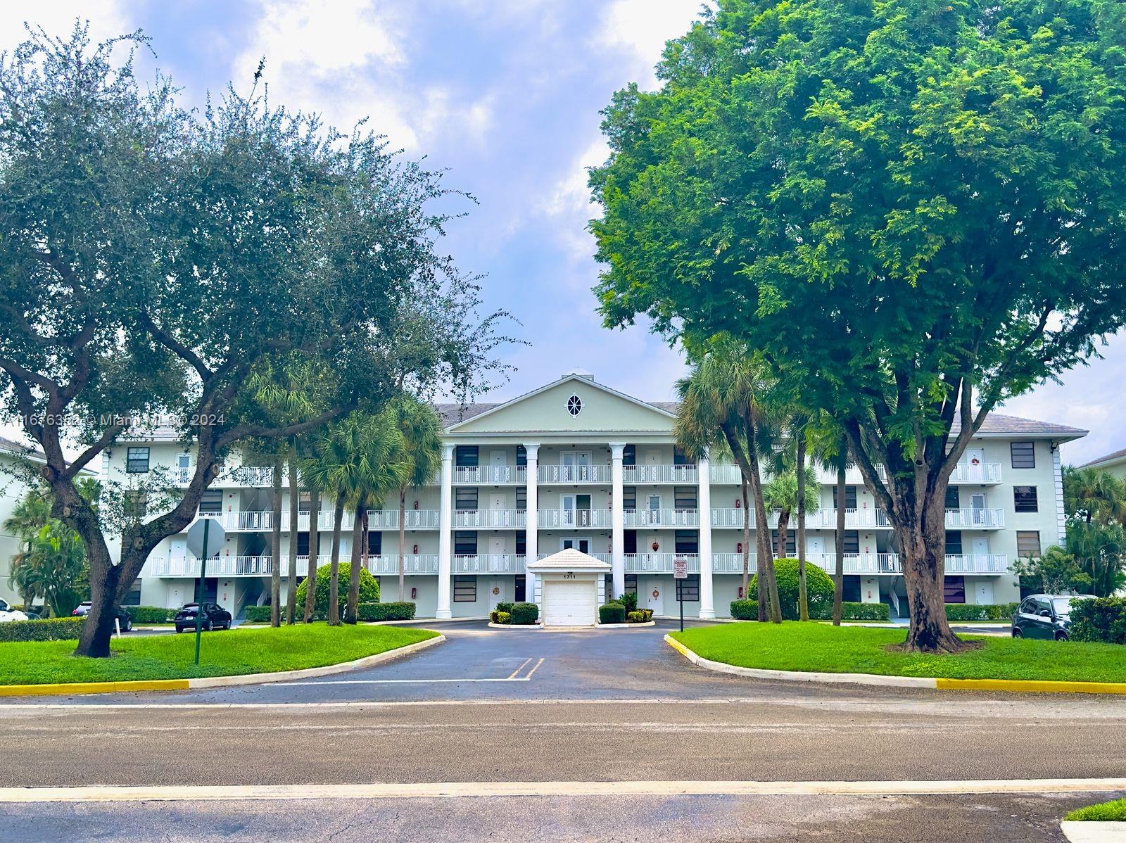 a view of a building with a yard