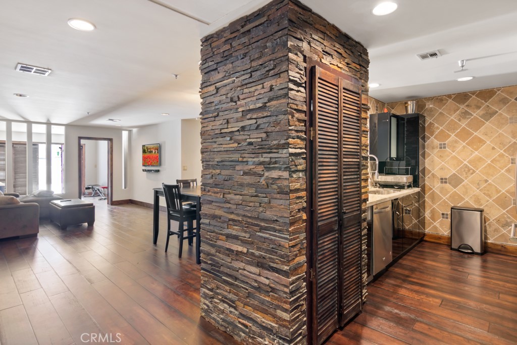 a kitchen with a sink cabinets and wooden floor