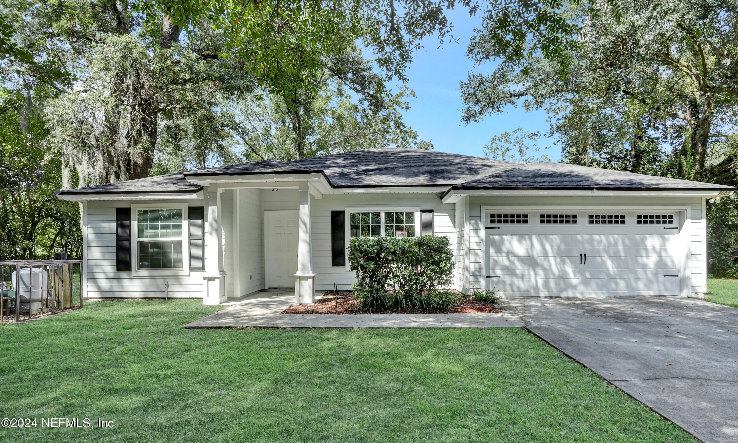 a front view of house with a garden and patio