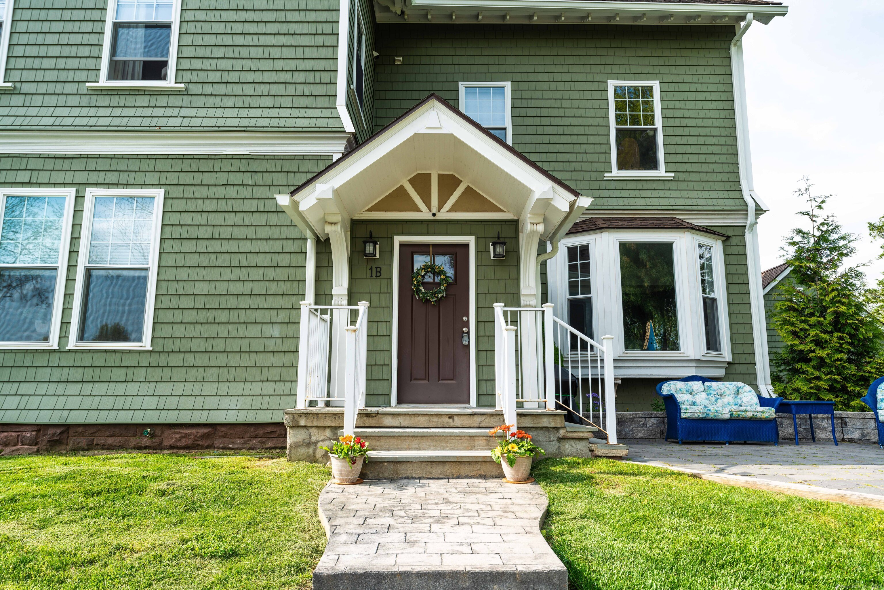 a front view of a house with garden