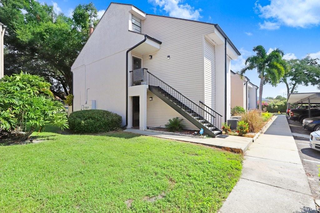 a view of house with yard and entertaining space