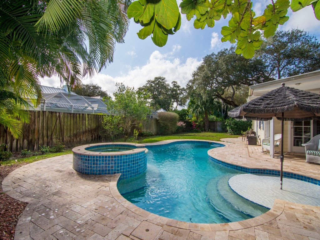 a view of a backyard with swimming pool