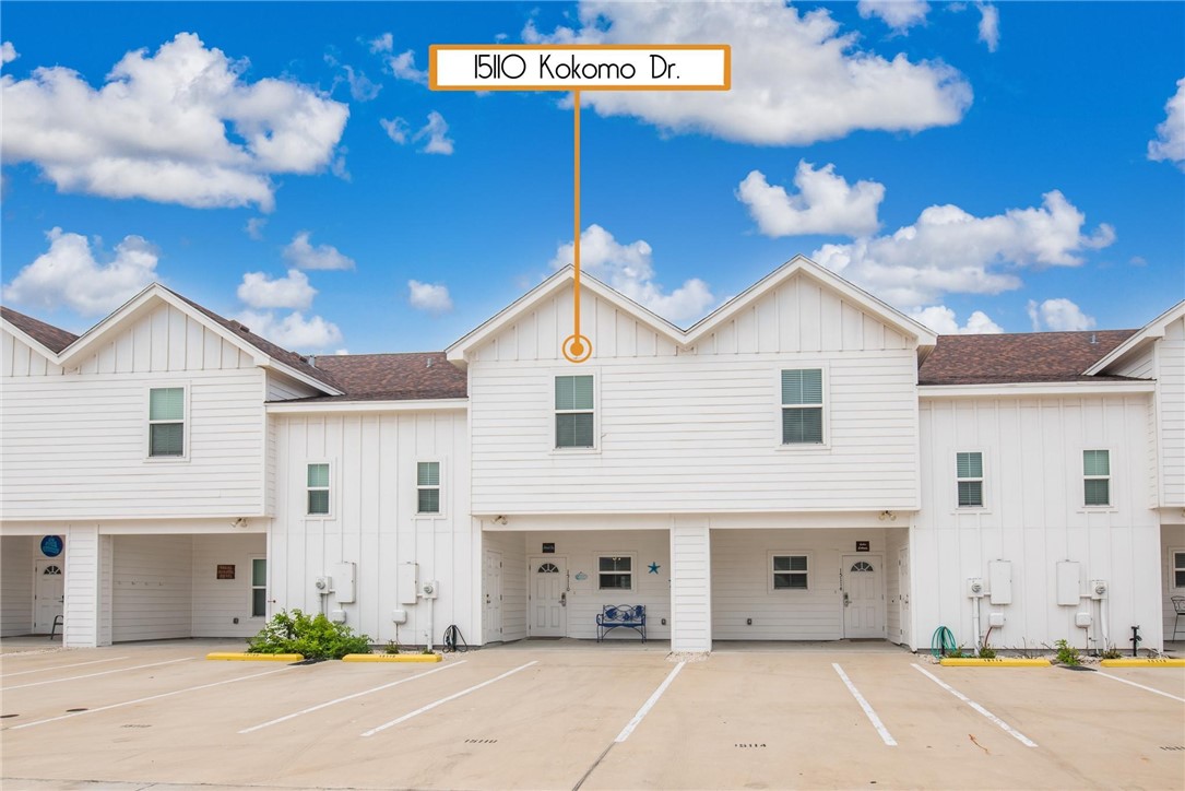 a view of a white house with a garage