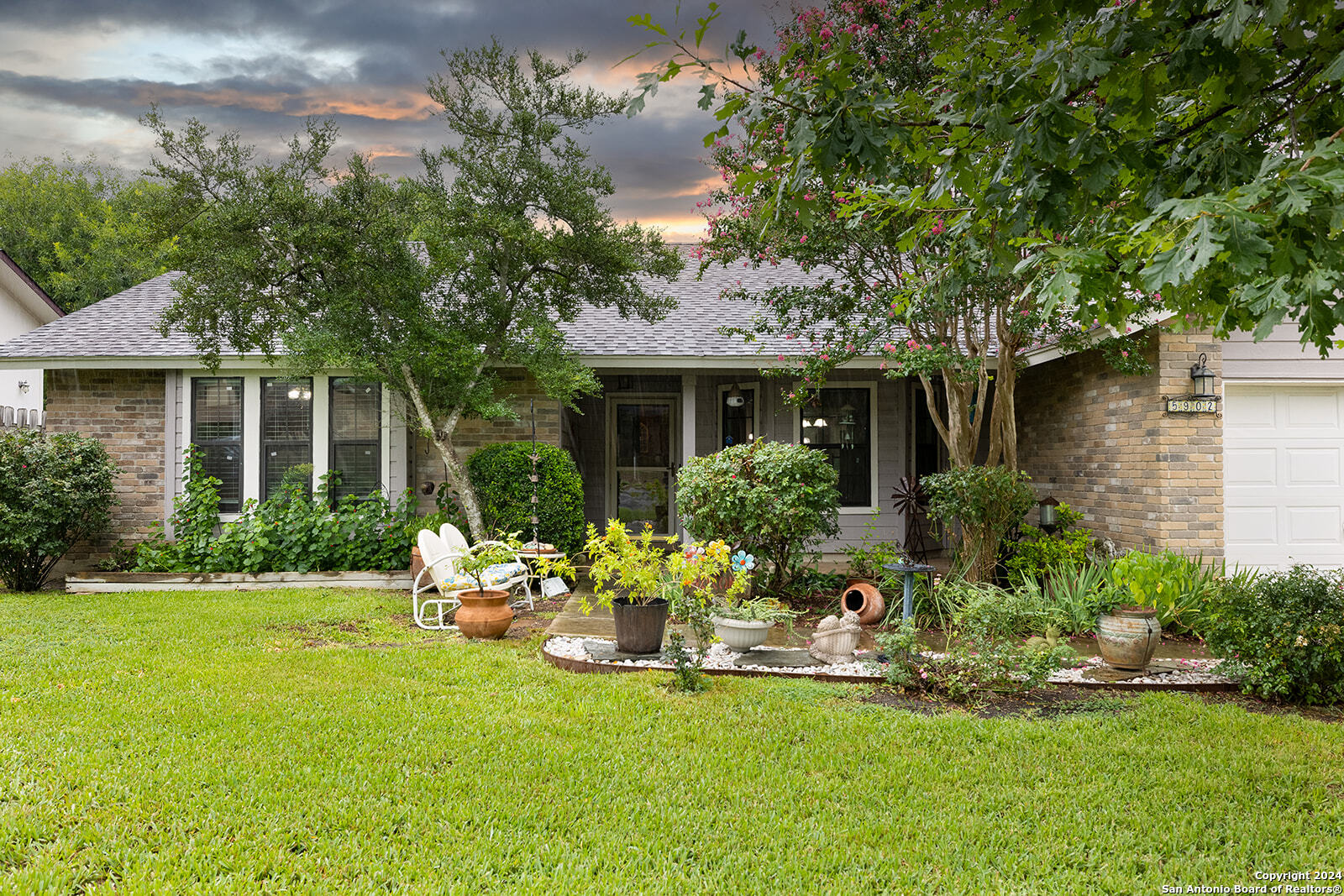 a front view of house with yard and outdoor seating