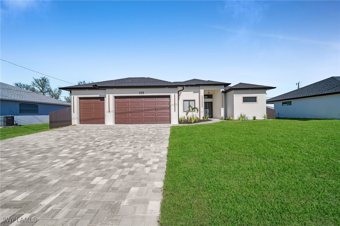 a front view of house with yard and green space