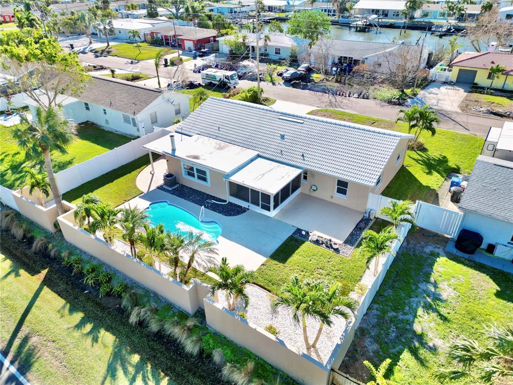 an aerial view of a house with a yard basket ball court and outdoor seating