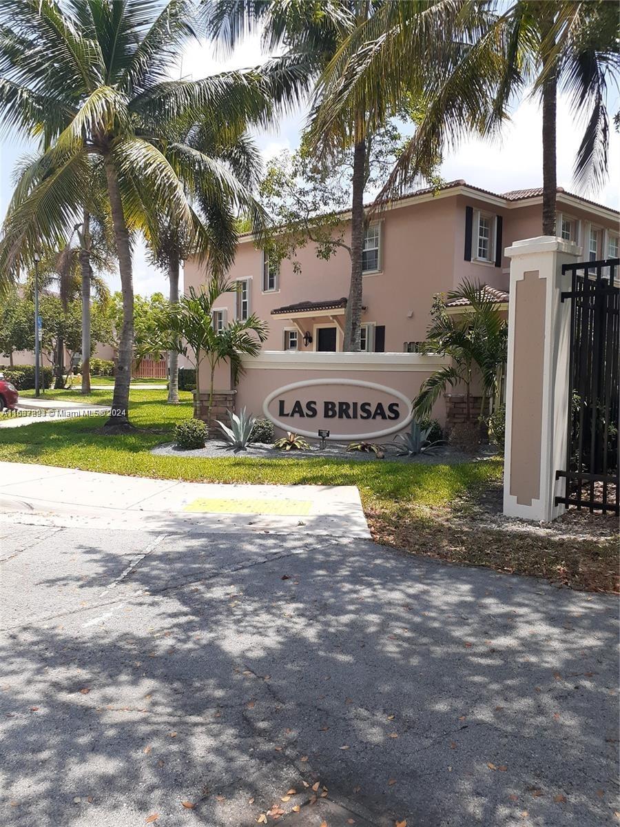 a view of a house with swimming pool and a yard