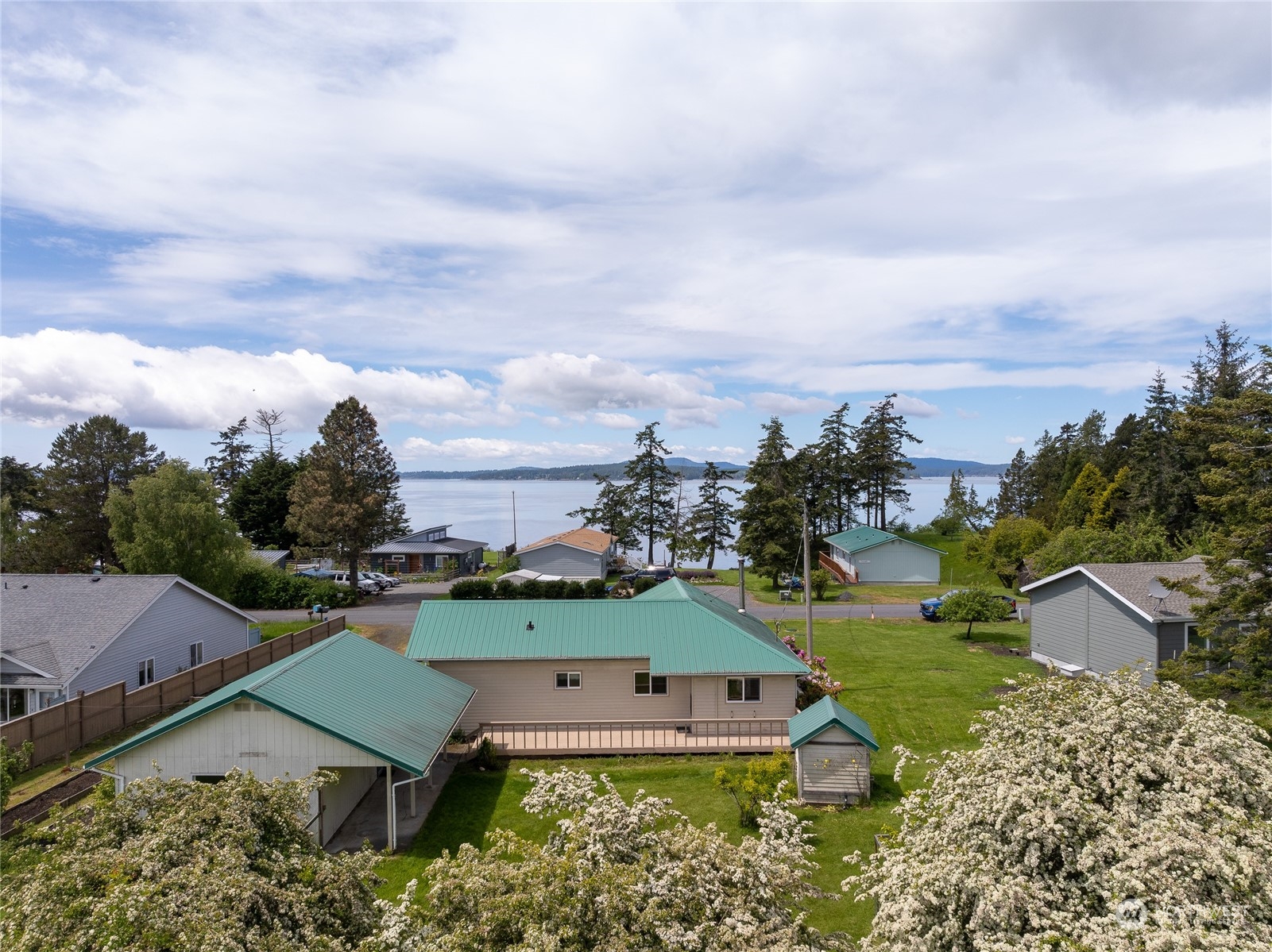 an aerial view of a house with garden space and ocean view