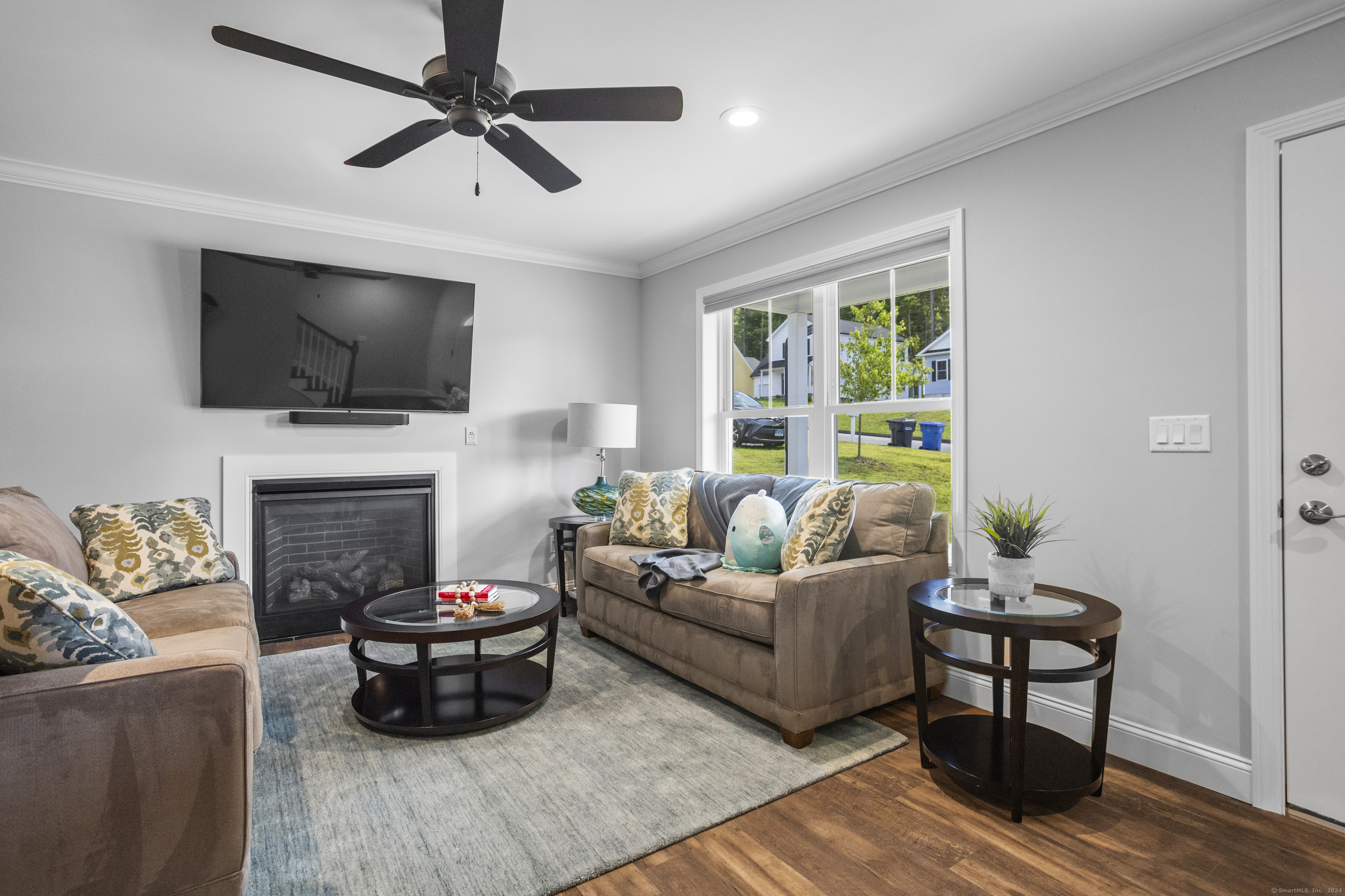 a living room with furniture a flat screen tv and a fireplace