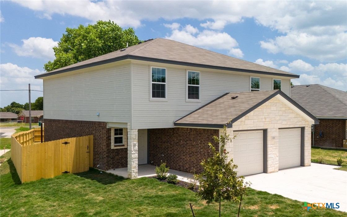 a aerial view of a house with yard