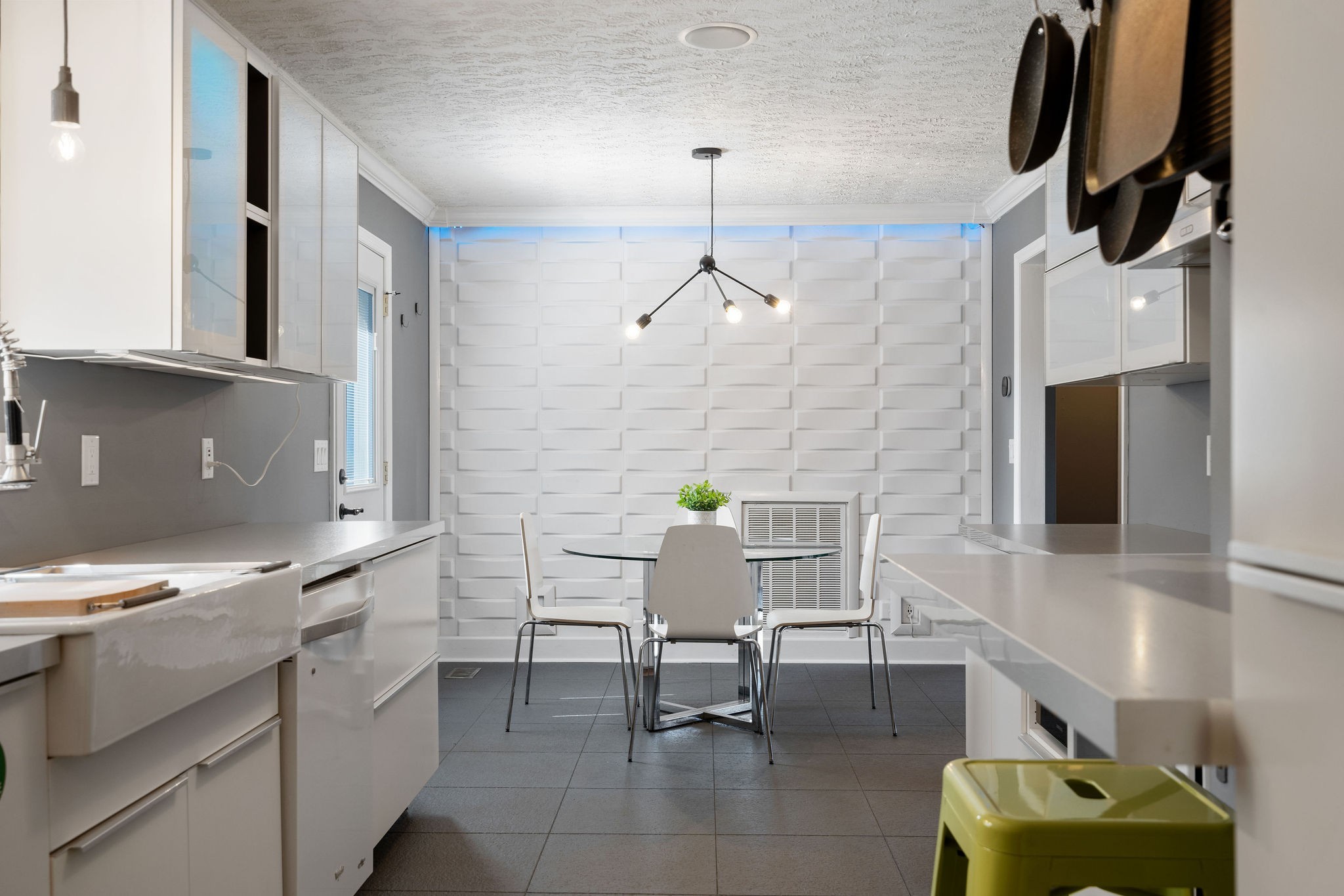 Dining space off of the kitchen features a sugar cane accent wall