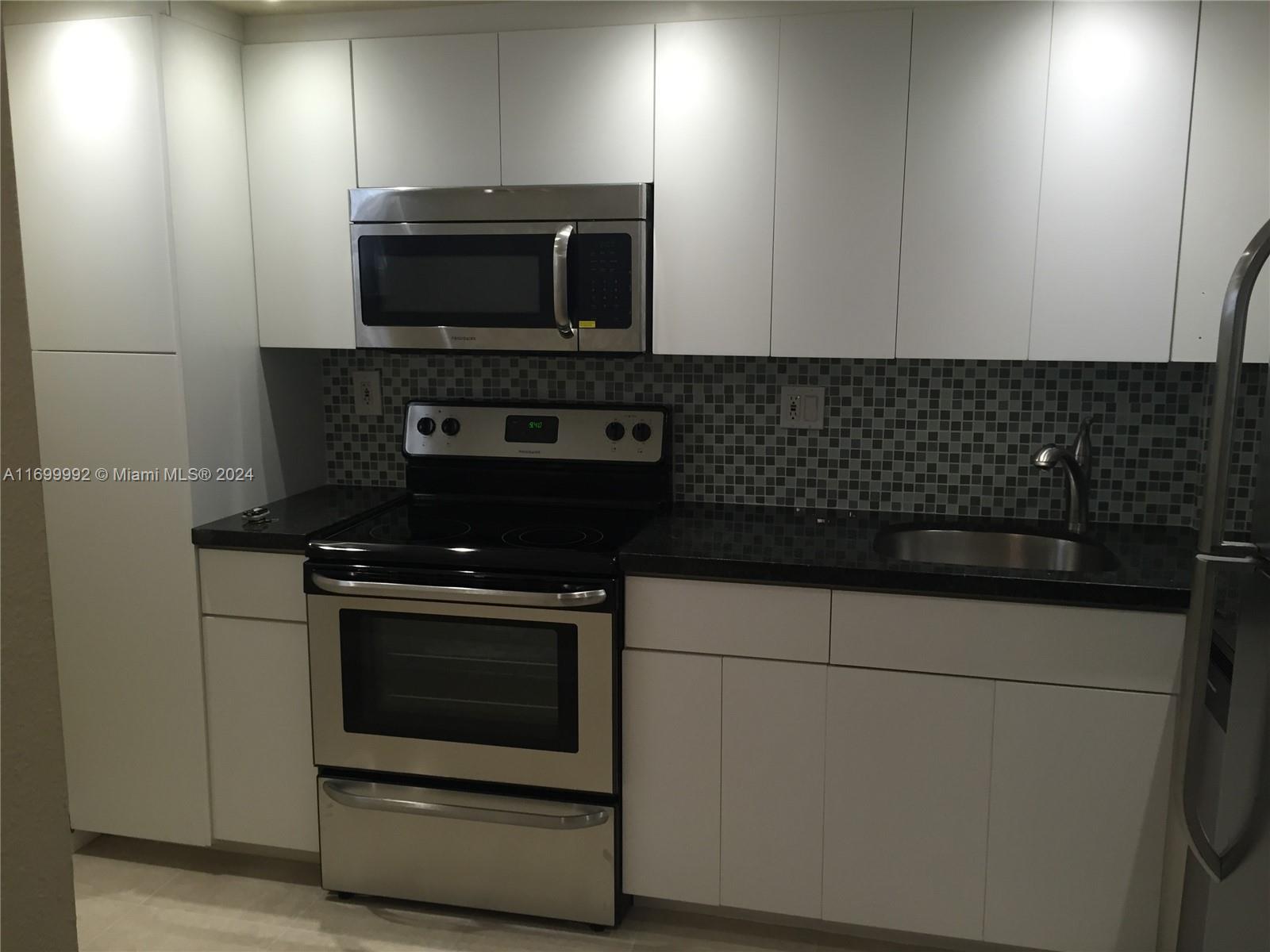 a stove top oven sitting inside of a kitchen