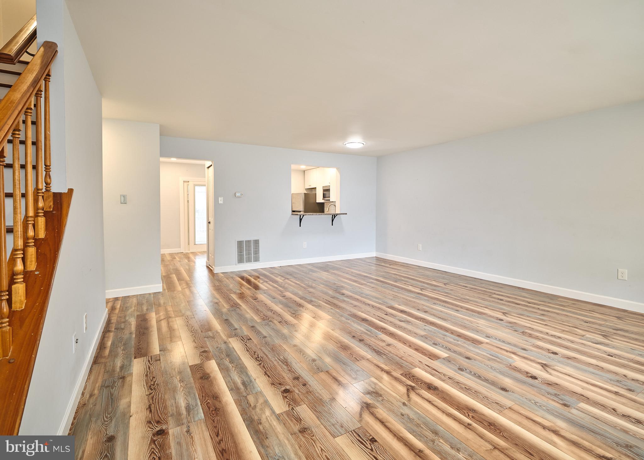 a view of empty room with wooden floor