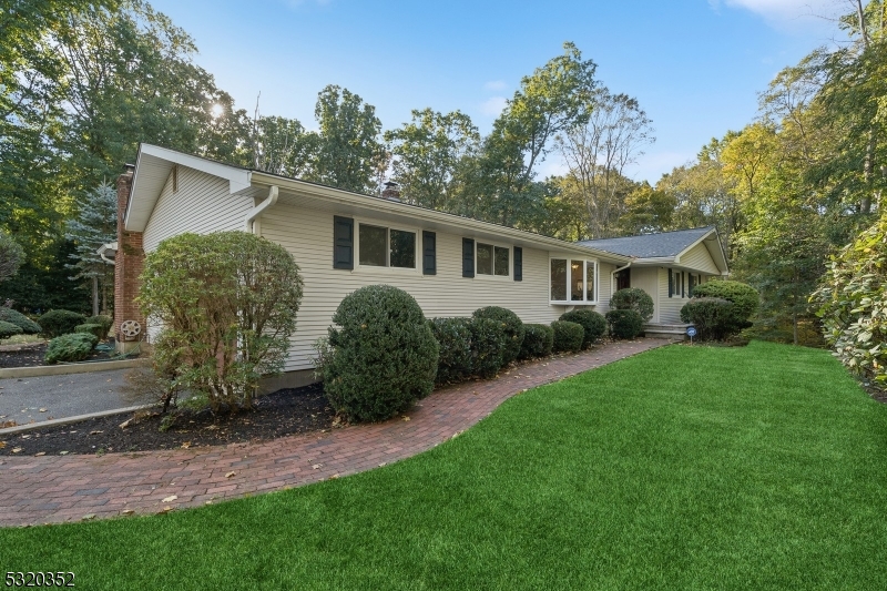 a view of a house with backyard and a garden