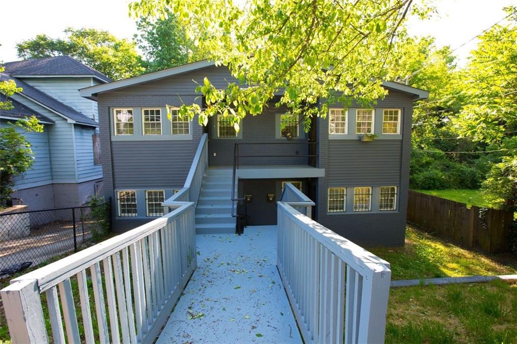 a view of a wooden house and a yard