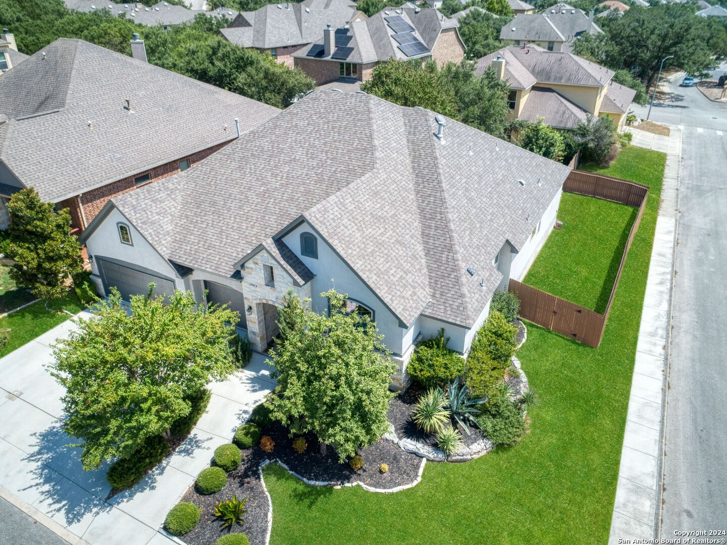 an aerial view of a house with a garden and plants