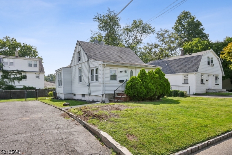 a view of a house with a big yard and large tree