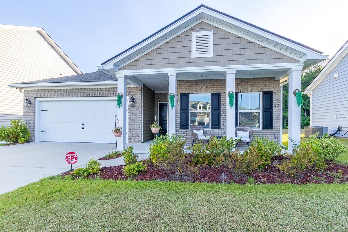 Craftsman-style house with a garage, a porch, cent