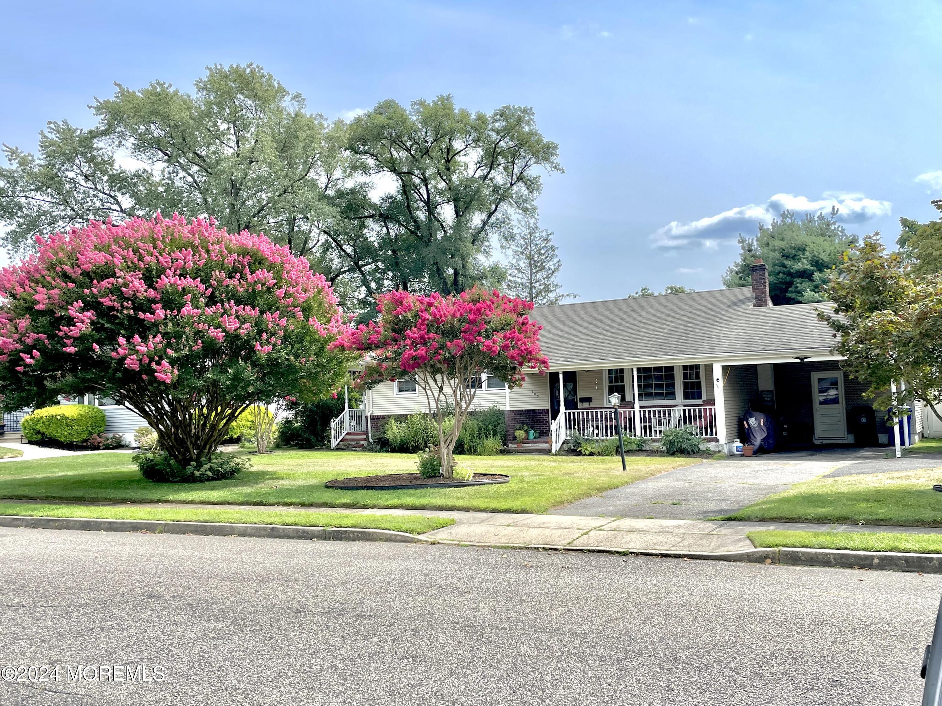 a front view of a house with a yard and fountain in middle