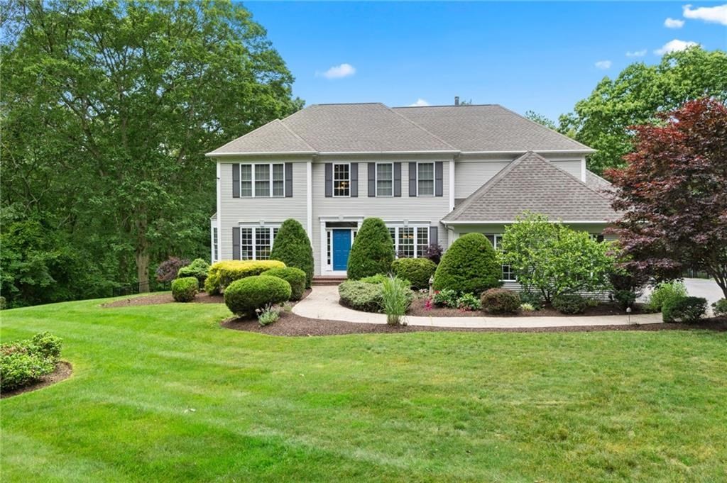 a view of a house with a yard and potted plants