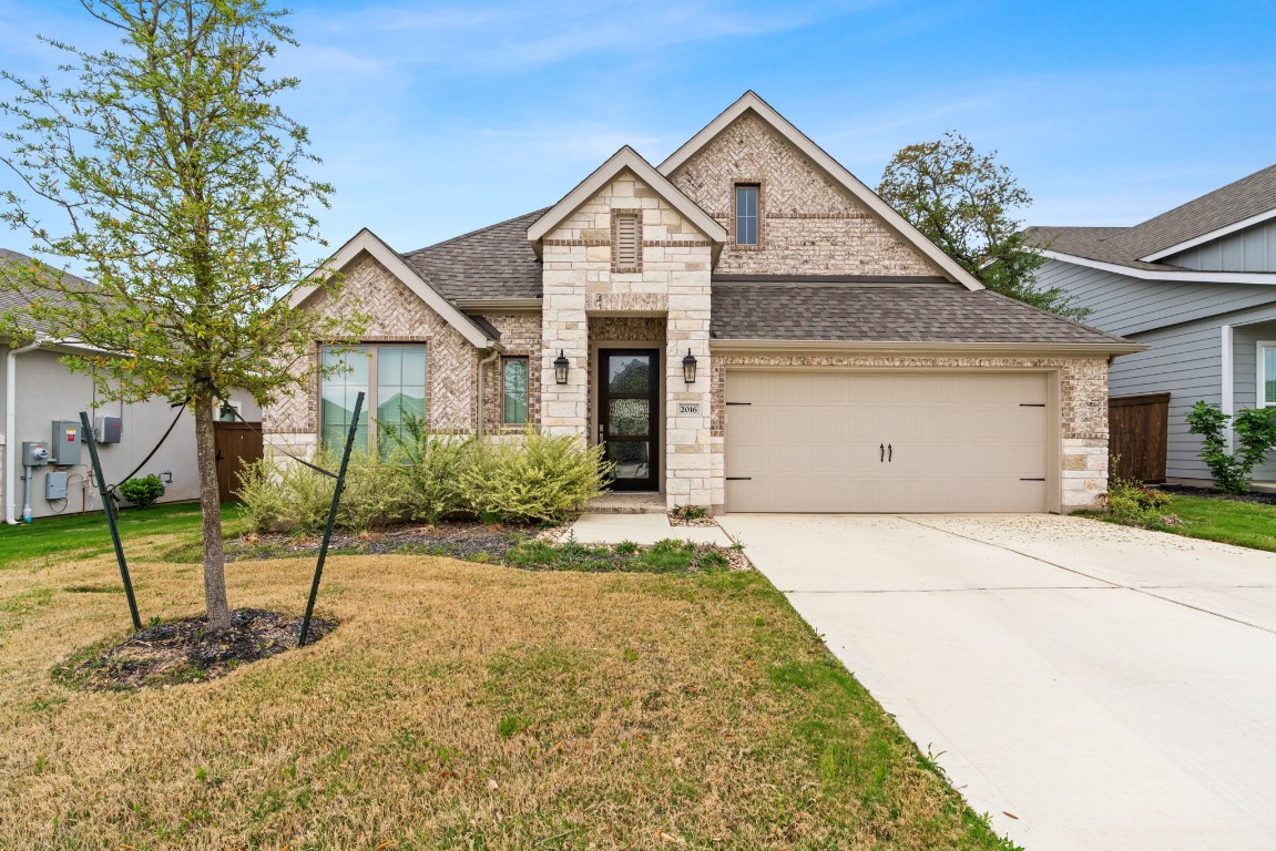 a front view of a house with a yard