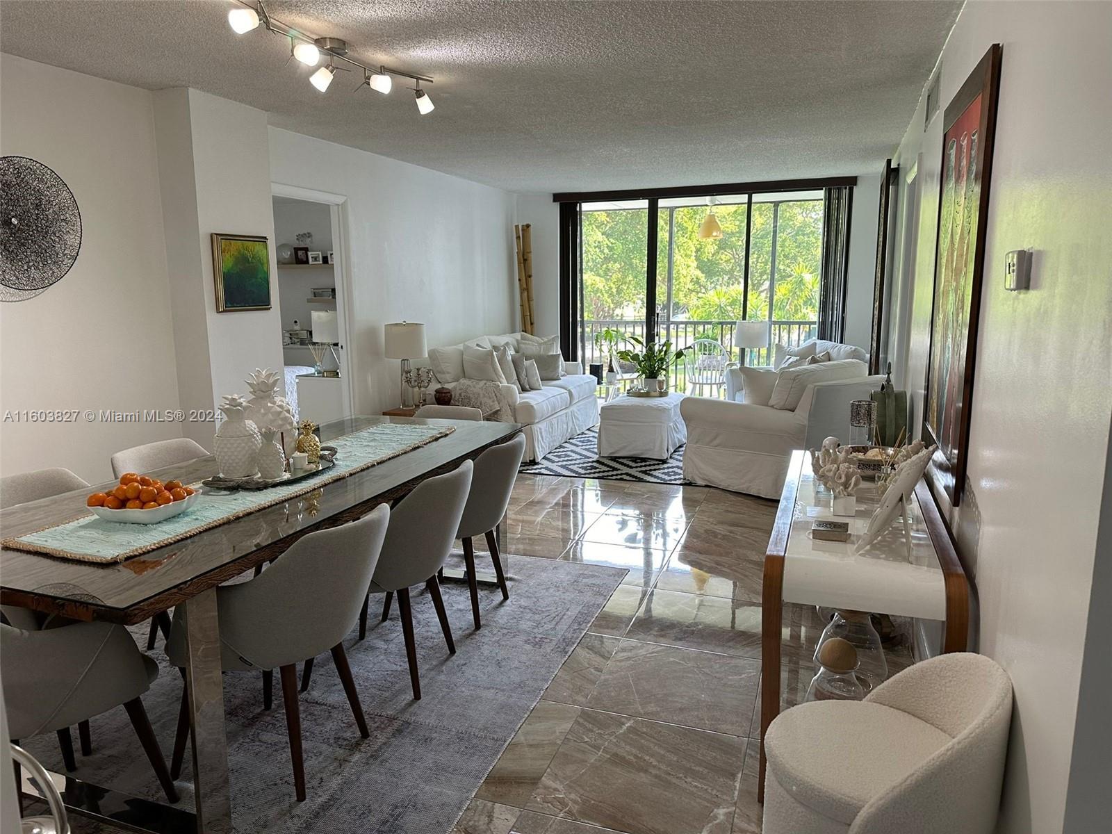 a view of a dining room with furniture and window